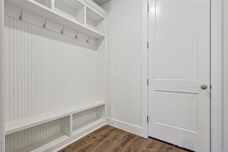 Mudroom with dark wood-style floors and baseboards