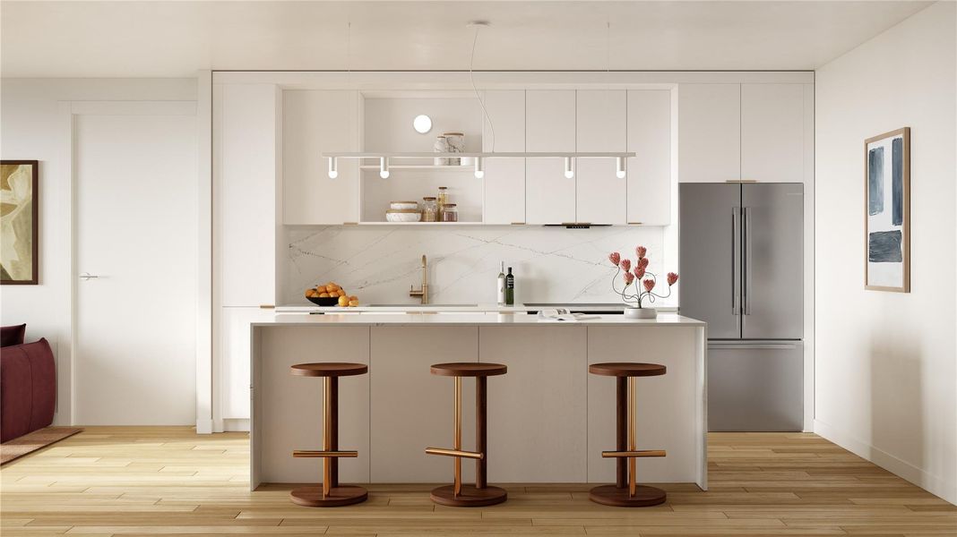 A minimalist kitchen with light wood, quartz countertops, modern appliances, and a striking black pendant.