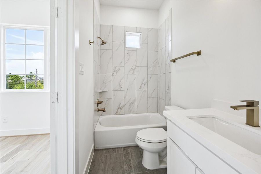 En-suite with tub/shower combo. Buyer to choose mirror and hardware to customize.