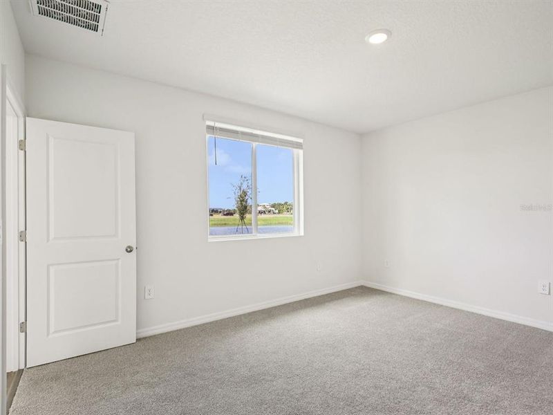 Spacious, unfurnished interior of a new home in The Grove at Stuart Crossing - Premier Series, Bartow (Image 22).