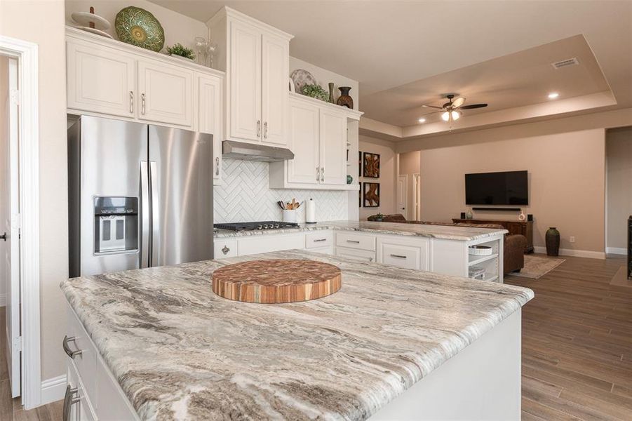 Kitchen with built in refrigerator and gas stove top