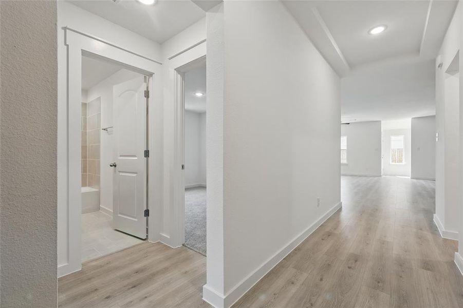 Hallway featuring light wood-style floors and recessed lighting