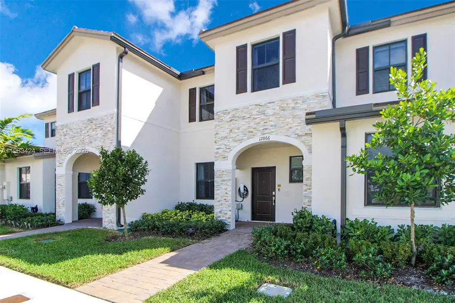 Front exterior of a new home in , Homestead, FL, highlighting curb appeal (Image 1). Front exterior of a new home in , Homestead, FL, highlighting curb appeal (Image 1).