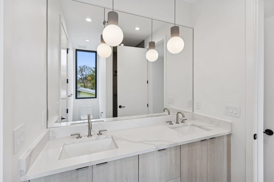 Full bathroom featuring double vanity and recessed lighting