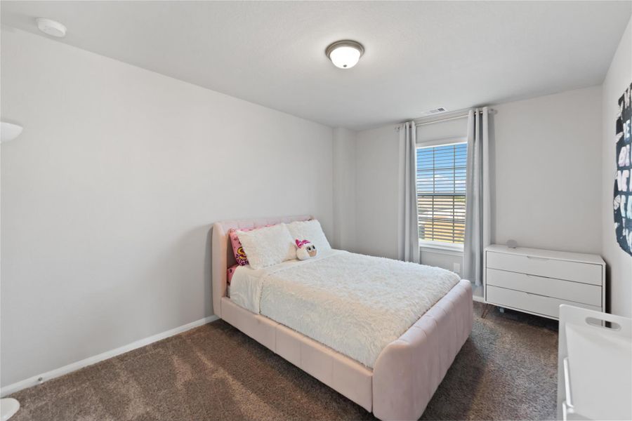 Each of the three secondary bedrooms features generous closet space, soft carpet underfoot, and bright natural light. Each of the three secondary bedrooms features generous closet space, soft carpet underfoot, and bright natural light.