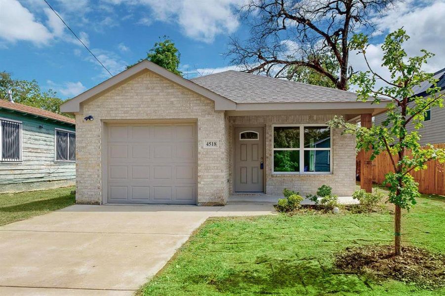 Ranch-style home featuring a garage and a front yard