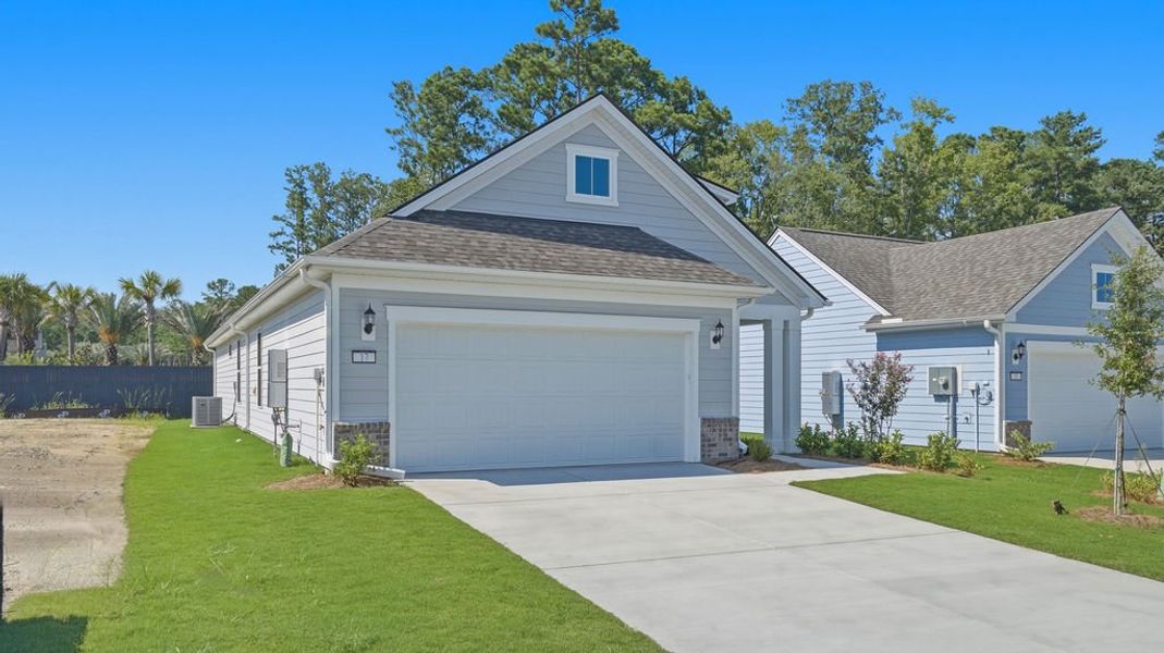 Front exterior of a new home in Sun City Hilton Head, Bluffton, SC, highlighting curb appeal (Image 20).