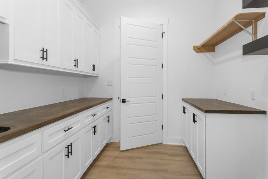 Large utility with folding table, sink and hanging area.