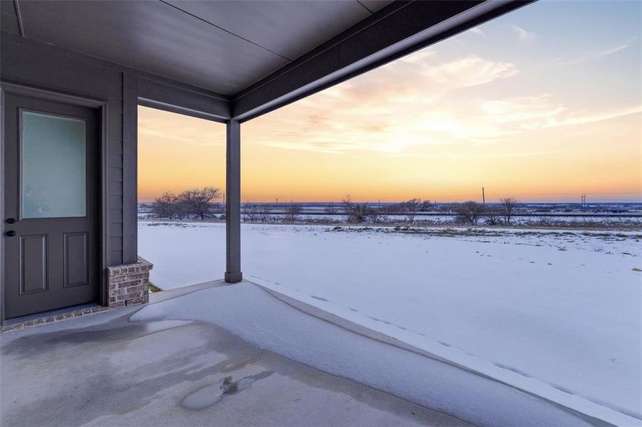 Snow covered patio with a patio