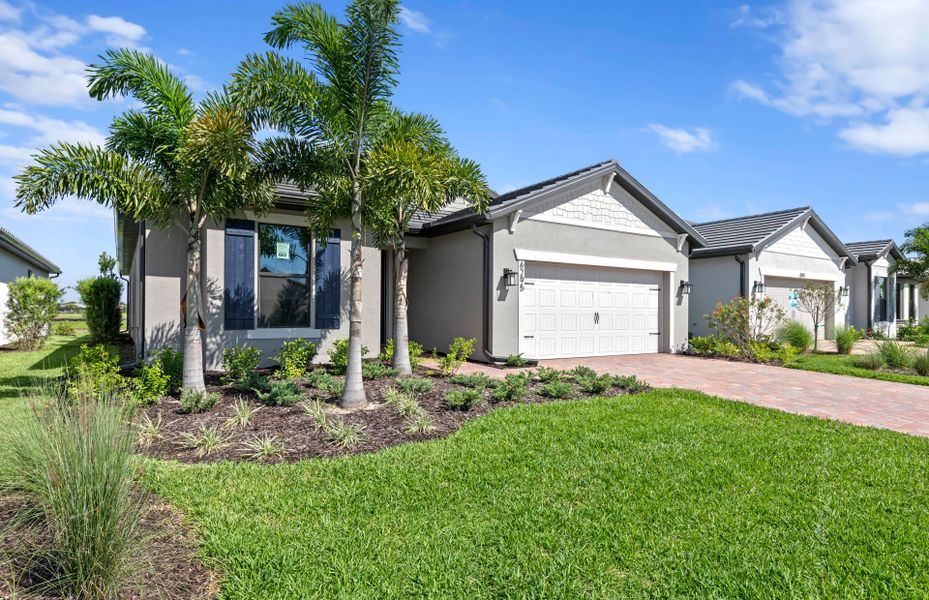 Front exterior of a new home in Del Webb Naples, Immokalee, FL, highlighting curb appeal (Image 23).