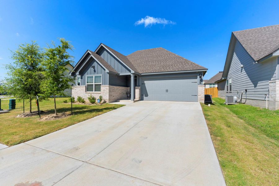 A welcoming facade with a broad driveway and mature landscaping creates appealing curb appeal. A welcoming facade with a broad driveway and mature landscaping creates appealing curb appeal.