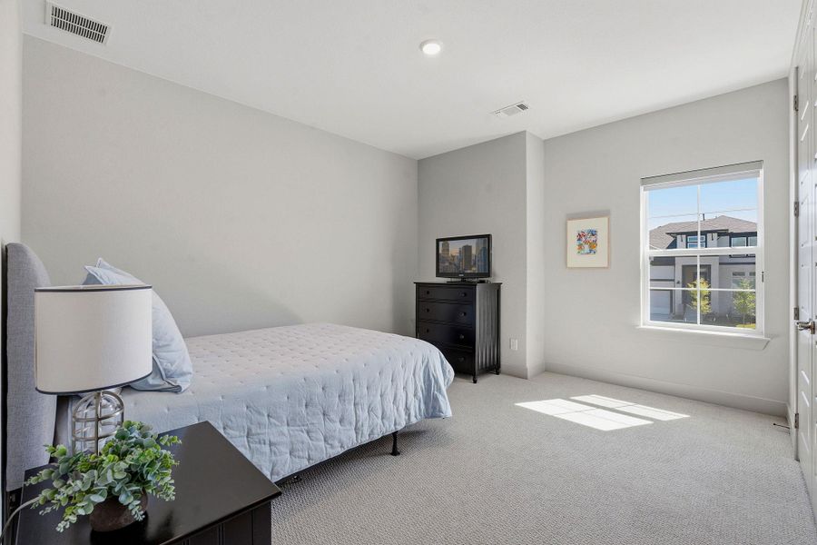 Bedroom with light carpet and baseboards Bedroom with light carpet and baseboards