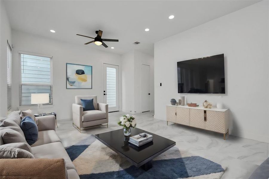 Bask in the glow of natural light and enjoy the ambiance provided by recessed lighting, creating an inviting atmosphere for relaxation and entertaining in the first-floor living area.