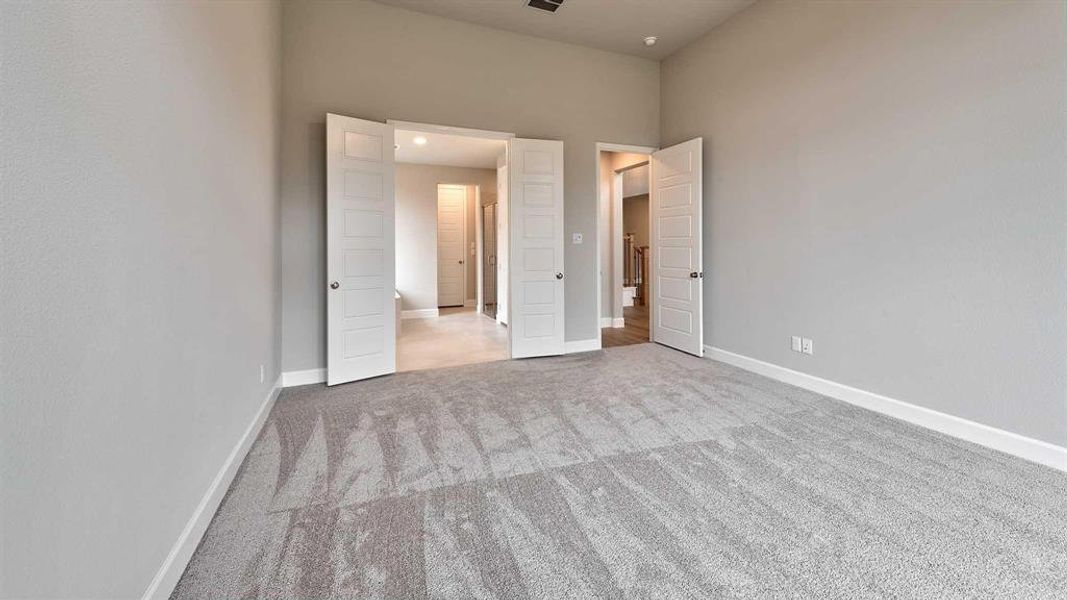 Bedroom featuring light colored carpet