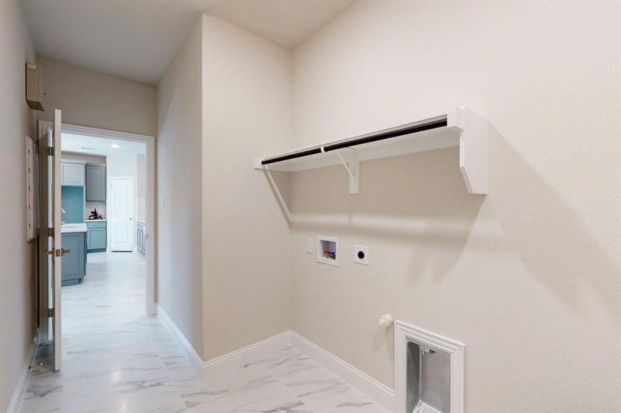 Laundry area with gas dryer hookup, washer hookup, light tile floors, and electric dryer hookup