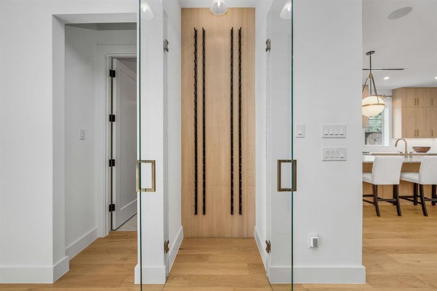 Hall with light wood-type flooring and recessed lighting