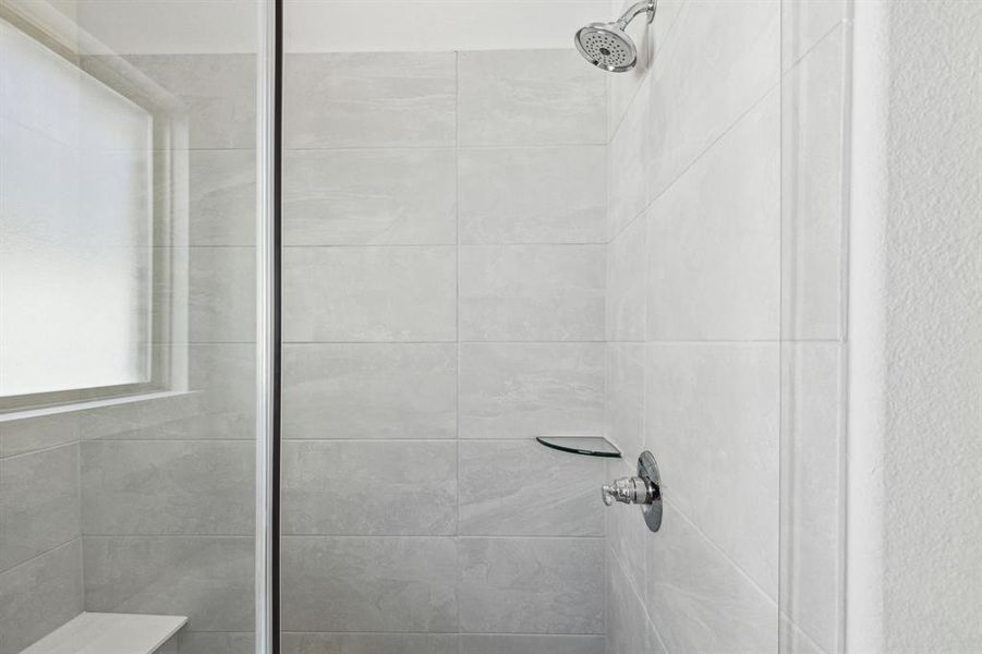 Bathroom featuring a tile shower