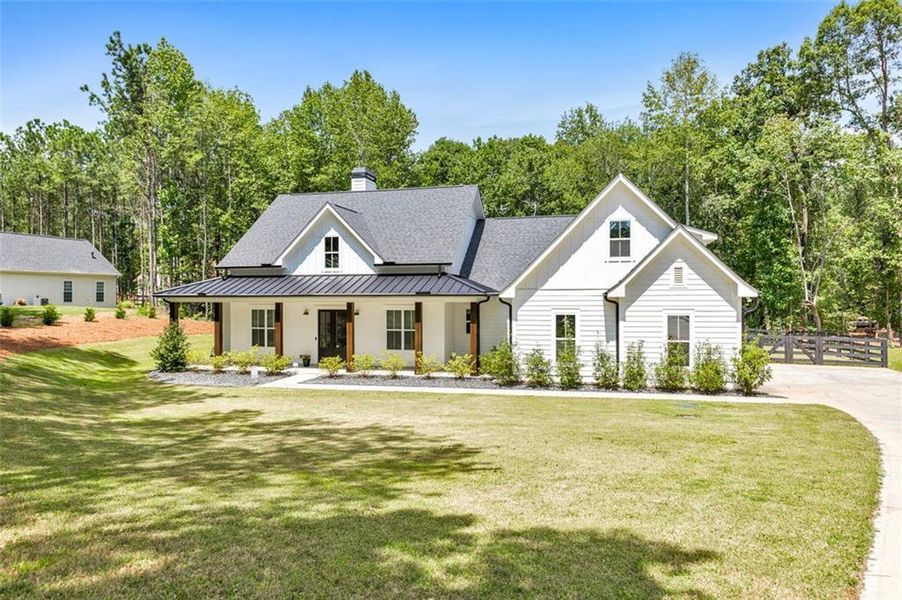 Front exterior of a new home in , Woodstock, GA, highlighting curb appeal (Image 24).