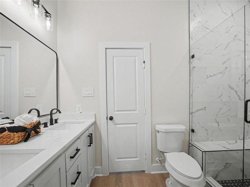 Bathroom featuring a dual vanity with undermount sinks, white countertops, and matte black hardware Bathroom featuring a dual vanity with undermount sinks, white countertops, and matte black hardware