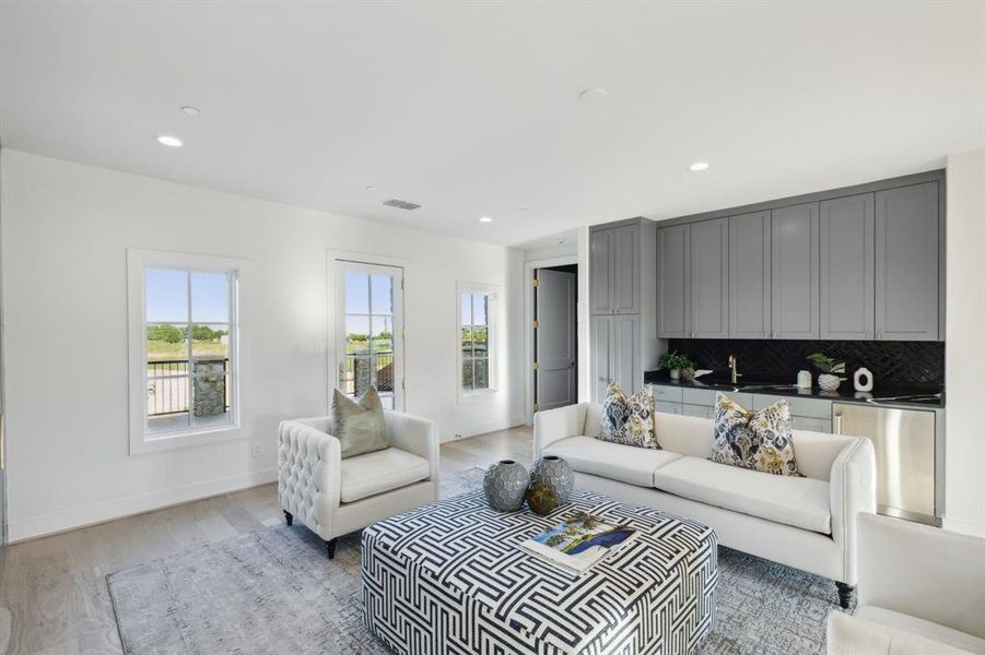 Living room with sink and light hardwood / wood-style flooring