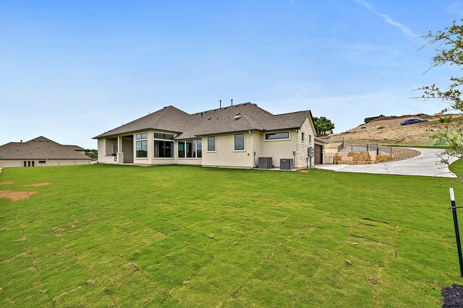A spacious backyard with newly laid sod complements the contemporary home's exterior.