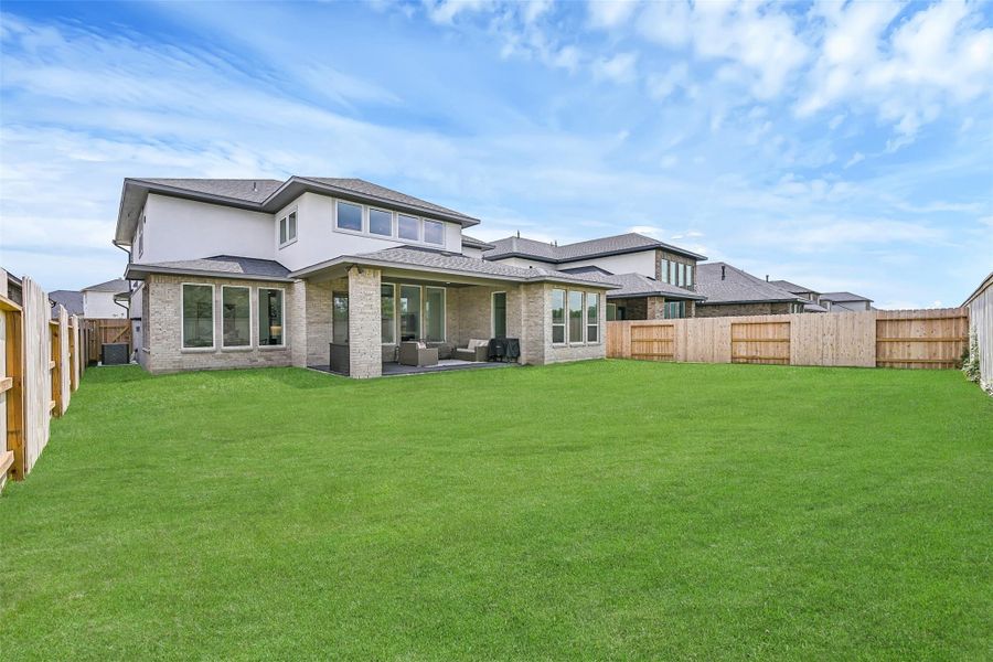 Front exterior of a new home in Avalon at Friendswood 60s, Friendswood, TX, highlighting curb appeal (Image 1). Front exterior of a new home in Avalon at Friendswood 60s, Friendswood, TX, highlighting curb appeal (Image 1).