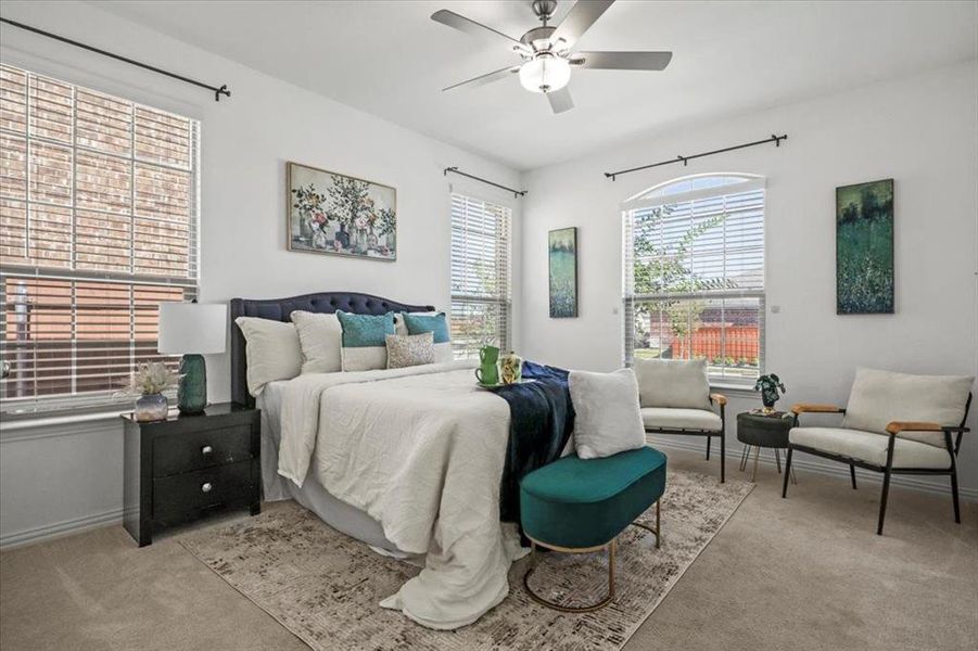 Bedroom with light colored carpet and a ceiling fan Bedroom with light colored carpet and a ceiling fan