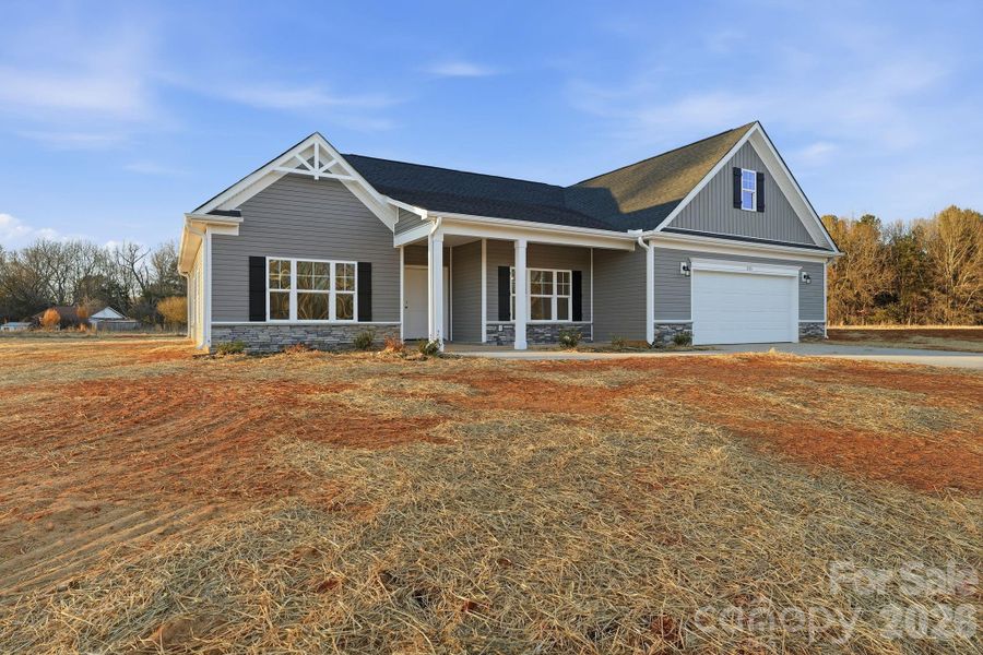 Front exterior of a new home in , Troutman, NC, highlighting curb appeal (Image 15).