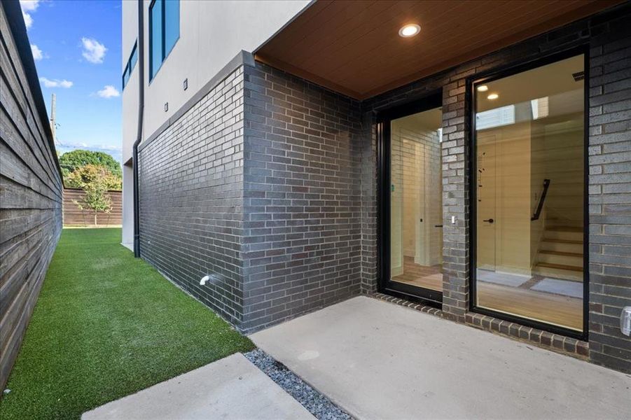 Property entrance with brick siding and a patio Property entrance with brick siding and a patio