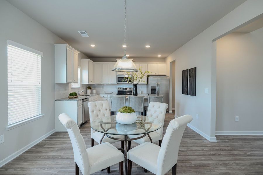 Well-designed kitchen overlooks the adjoining breakfast area and family room