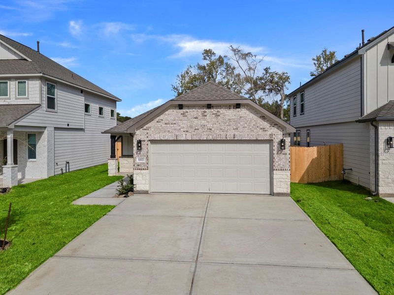 Front exterior of a new home in Cypresswood Landing, Humble, TX, highlighting curb appeal (Image 2).