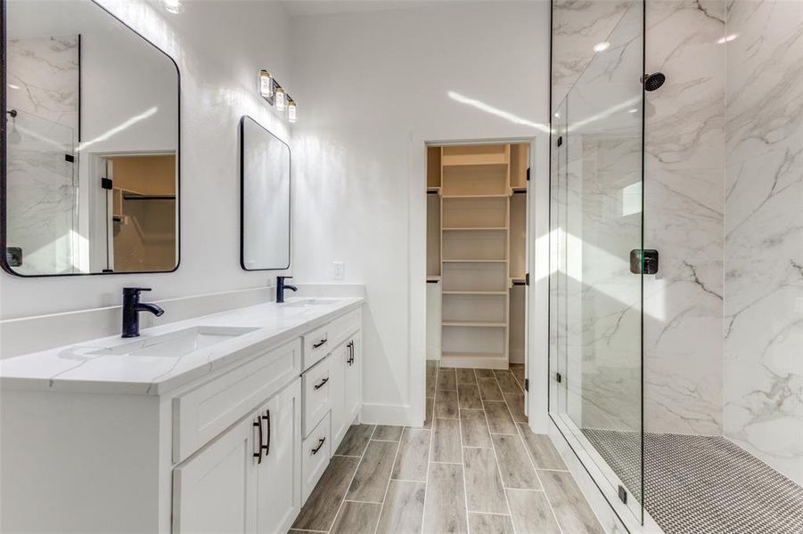 Bathroom featuring vanity and a shower with shower door