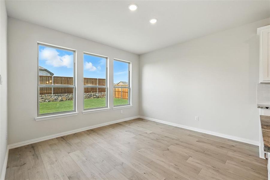Empty room with light wood-style flooring and recessed lighting Empty room with light wood-style flooring and recessed lighting