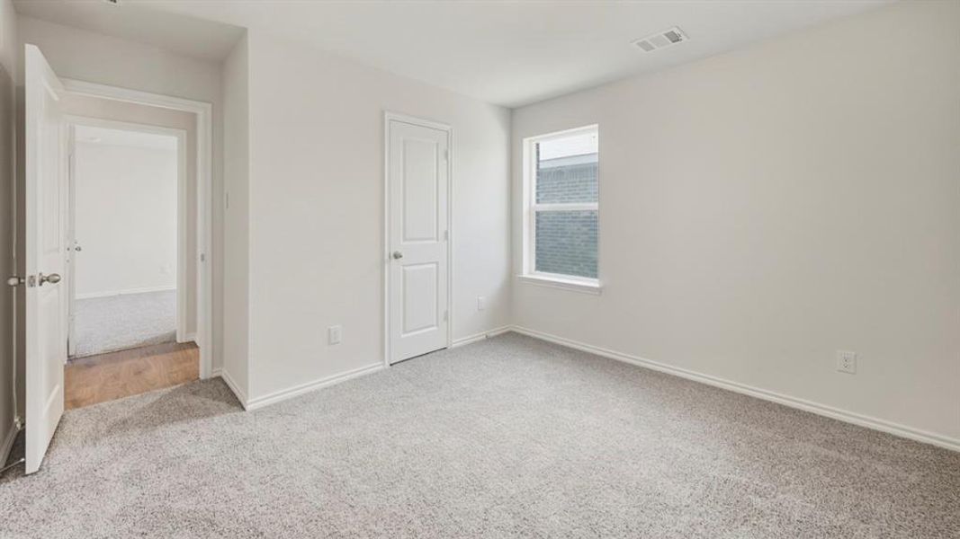 Unfurnished bedroom featuring light carpet and baseboards Unfurnished bedroom featuring light carpet and baseboards