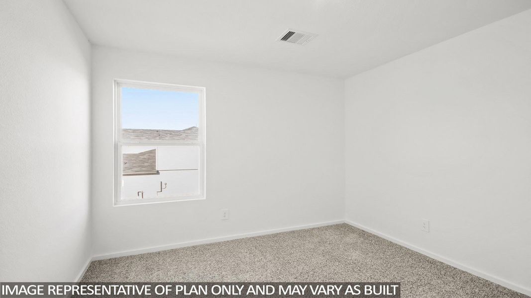 Neutral wall finishes and carpeted flooring in this bright room, featuring a single window and ceiling vent