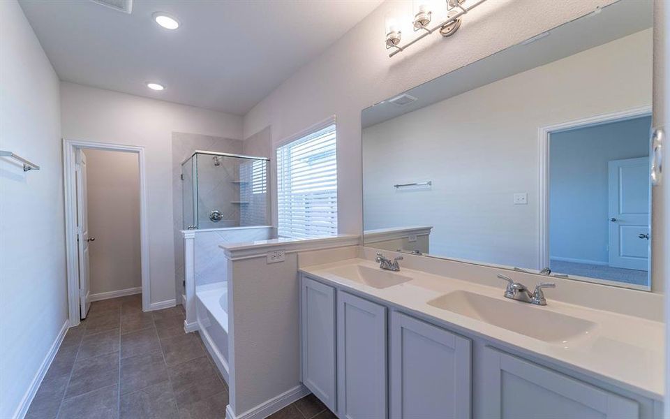 Dual vanity with integrated sinks and white cabinetry