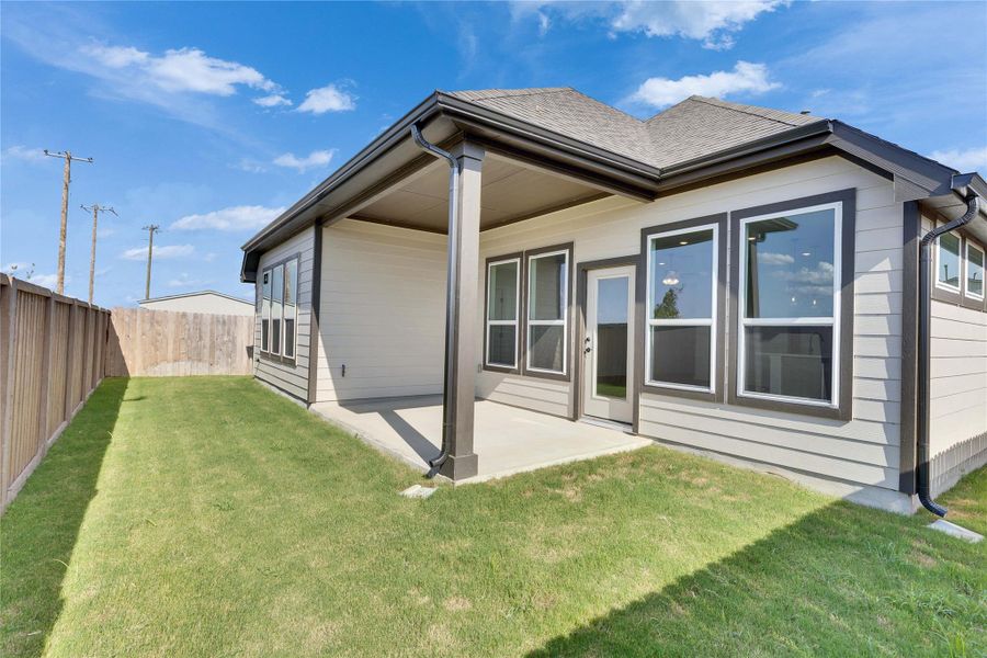 Back of house featuring a patio area, a fenced backyard, and a shingled roof Back of house featuring a patio area, a fenced backyard, and a shingled roof