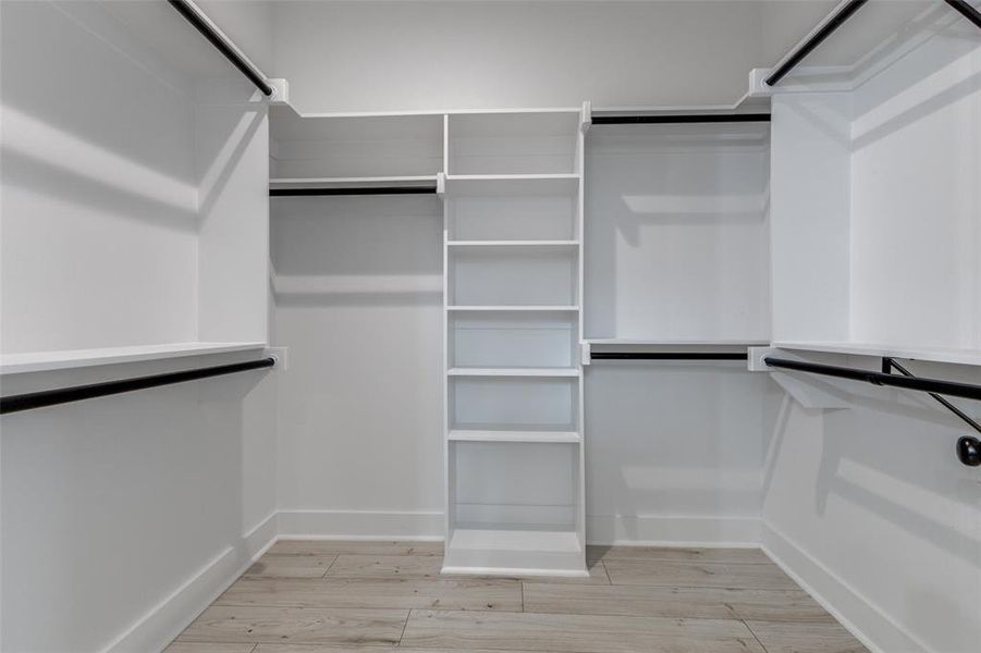 Walk in closet featuring light wood-style floors