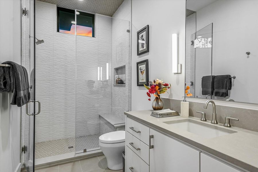Full bath with vanity, a stall shower, and light tile patterned flooring Full bath with vanity, a stall shower, and light tile patterned flooring