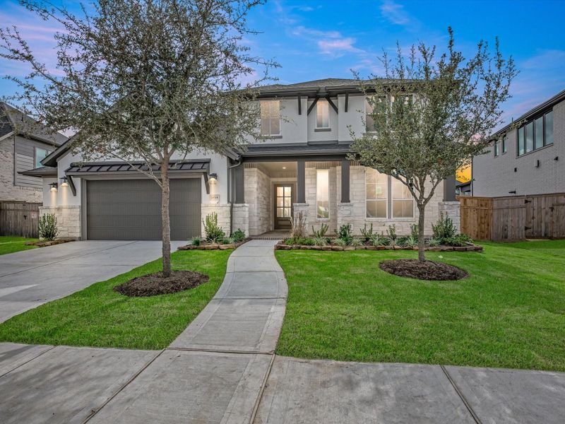 Front exterior of a new home in Cross Creek Ranch, Fulshear, TX, highlighting curb appeal (Image 2). Front exterior of a new home in Cross Creek Ranch, Fulshear, TX, highlighting curb appeal (Image 2).