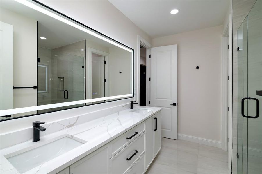 Bathroom with a shower with door and vanity