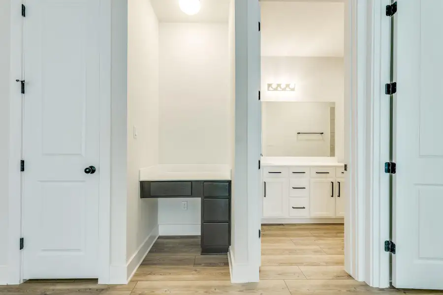 Bathroom featuring vanity and light wood finished floors