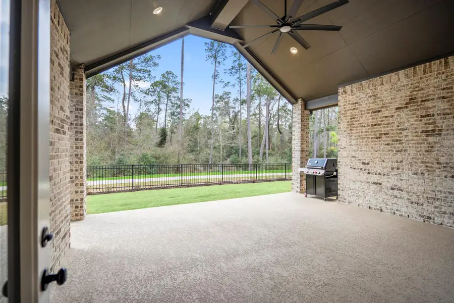 Oversized patio with no back neighbors and views of mature trees.