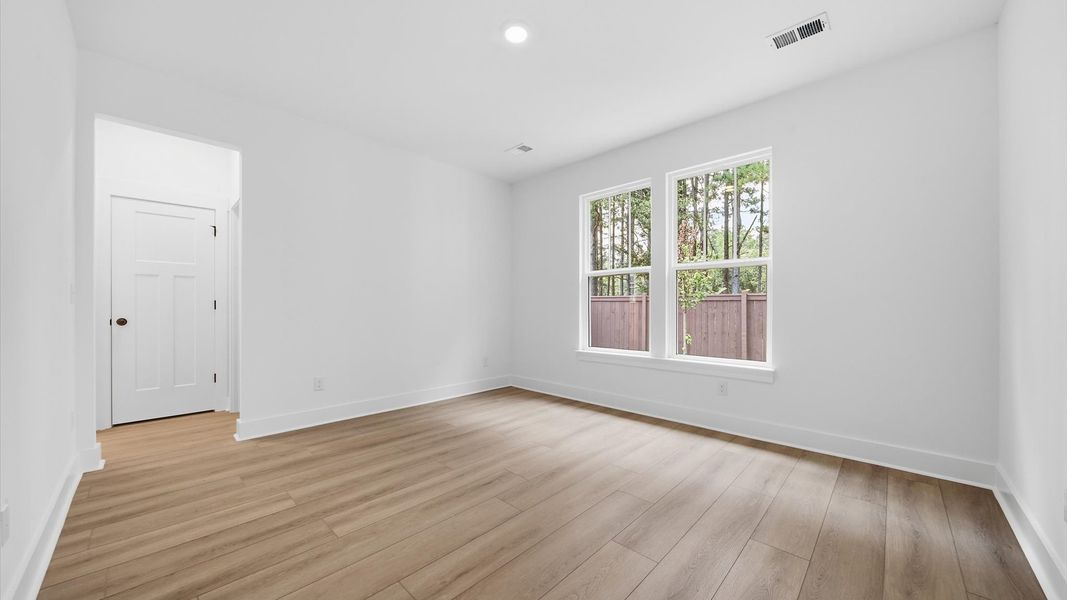 Superior layout with private, modern main level primary suite with LVP flooring in this leading DRB Homes design Superior layout with private, modern main level primary suite with LVP flooring in this leading DRB Homes design