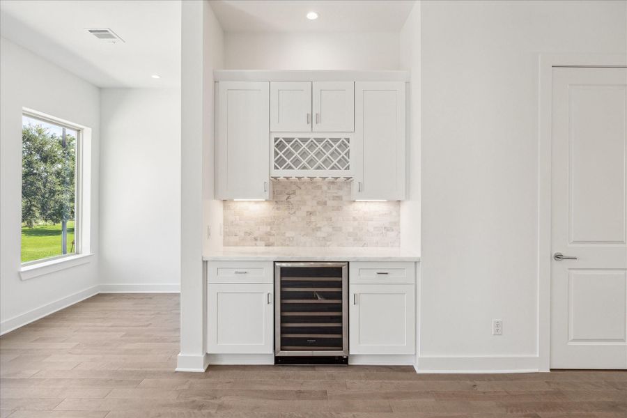 Dry Bar with Wine Refrigerator * Marble Backsplash * Lots of Cabinets * Wine Rack.