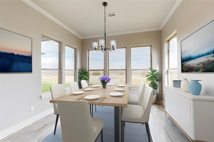 Dining area featuring light wood-type flooring, an inviting chandelier, and plenty of natural light