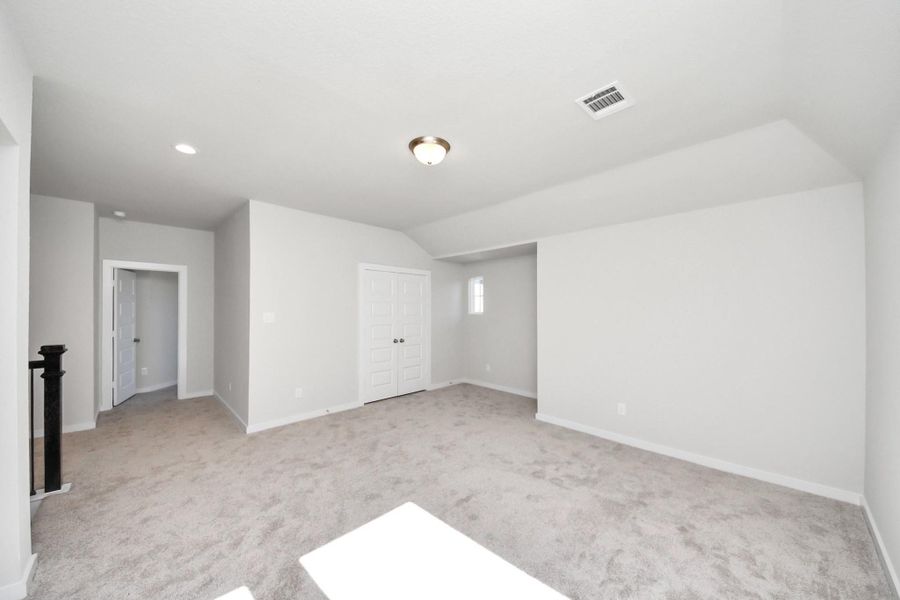 Ascend to relaxation in this fantastic game room! Ideal for both casual gatherings and adult gaming, it boasts plush carpet, lofty ceilings, custom paint, and ample windows for abundant natural light.