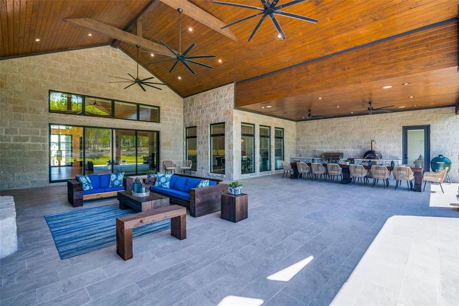 View of patio with outdoor lounge area and ceiling fan