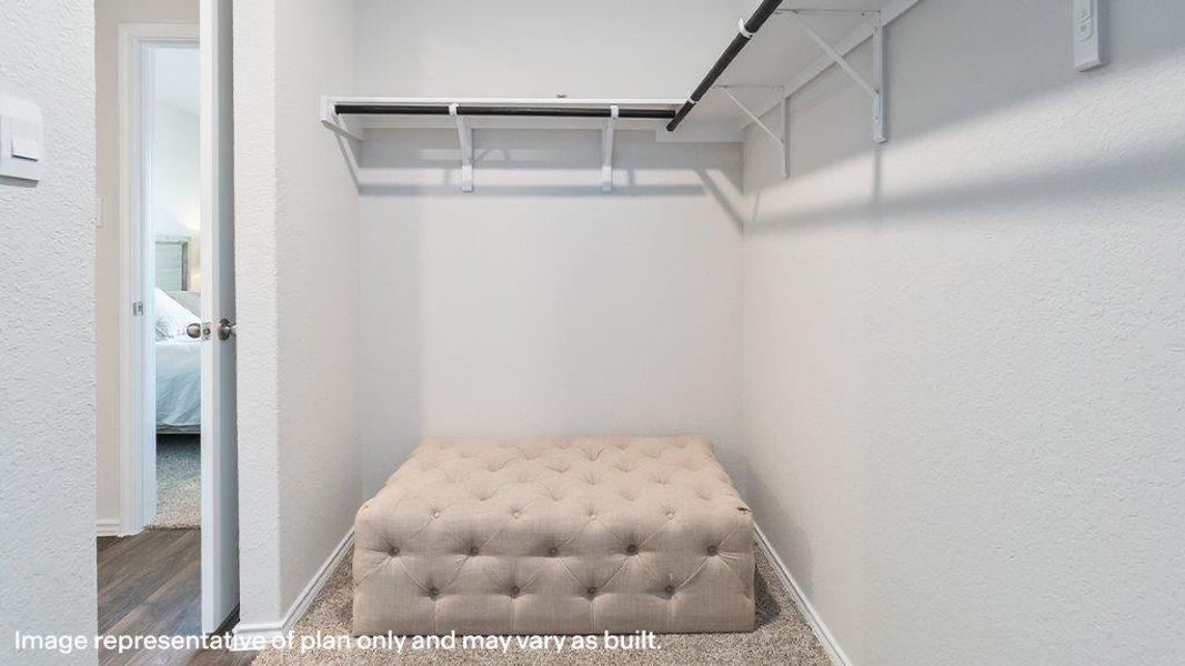 Discover optimal organization in this neatly appointed walk-in closet, offering ample storage potential. Discover optimal organization in this neatly appointed walk-in closet, offering ample storage potential.