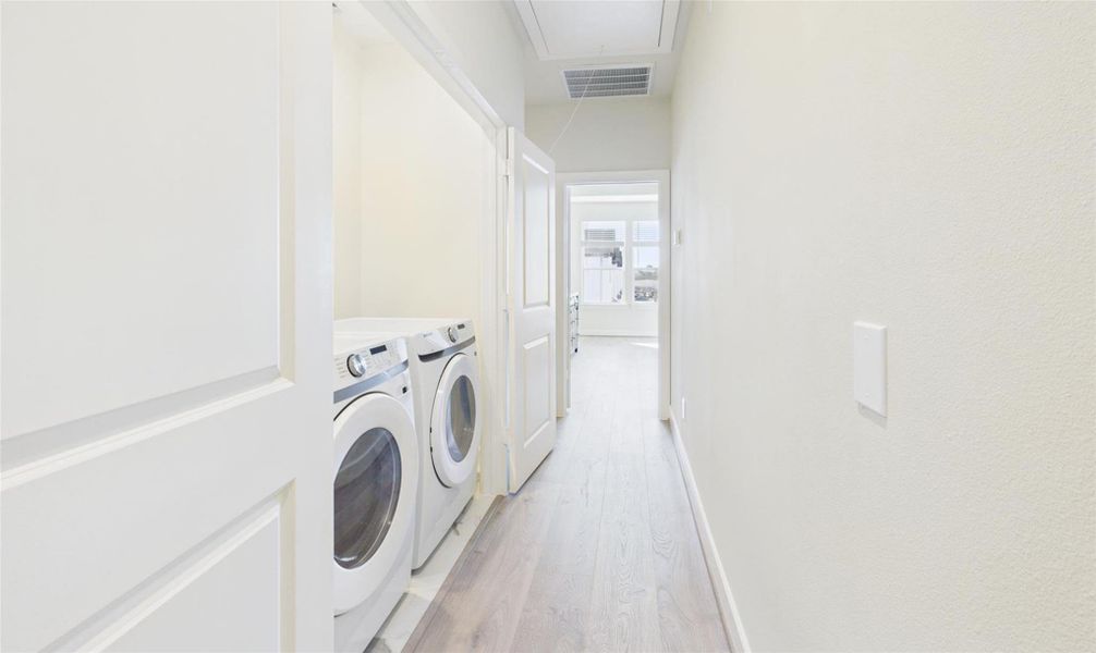 Utility room on the same floor as the primary bedroom